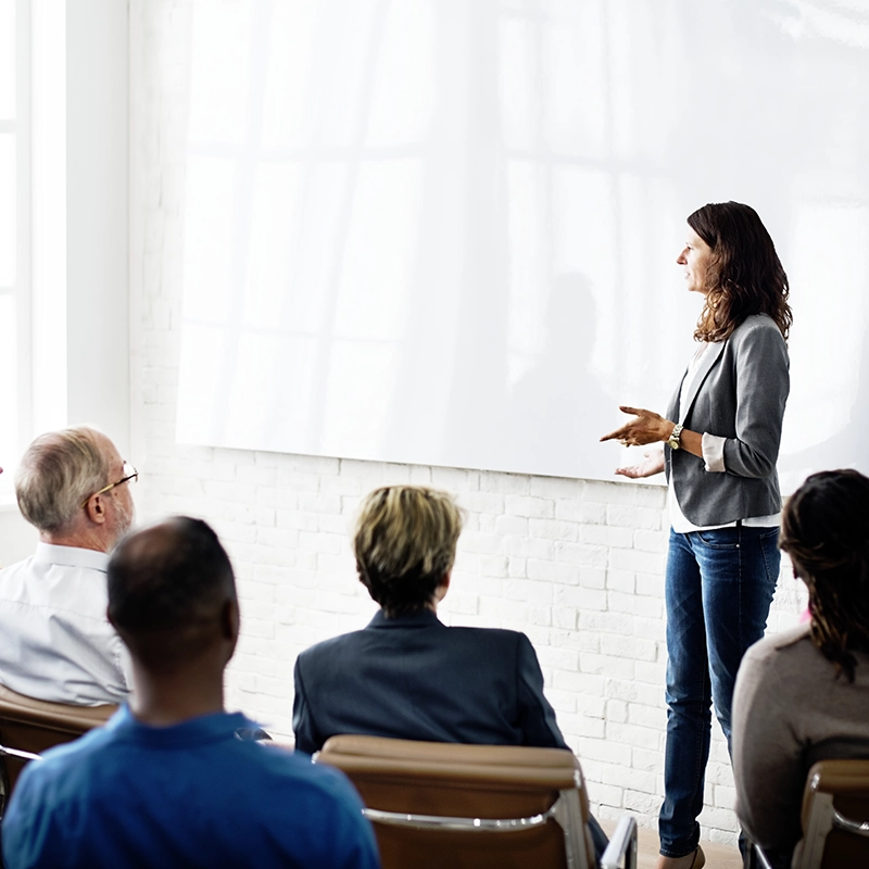 Person instructing a room of adults