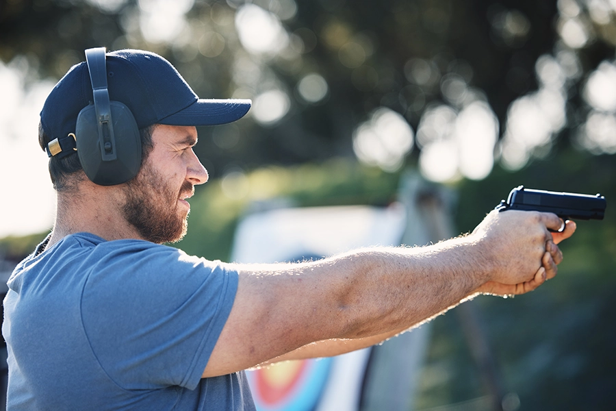 Man using firearm at shooting range