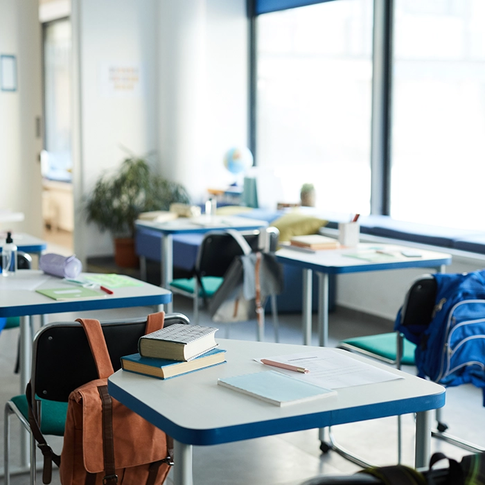Classroom desks and chairs with clutter