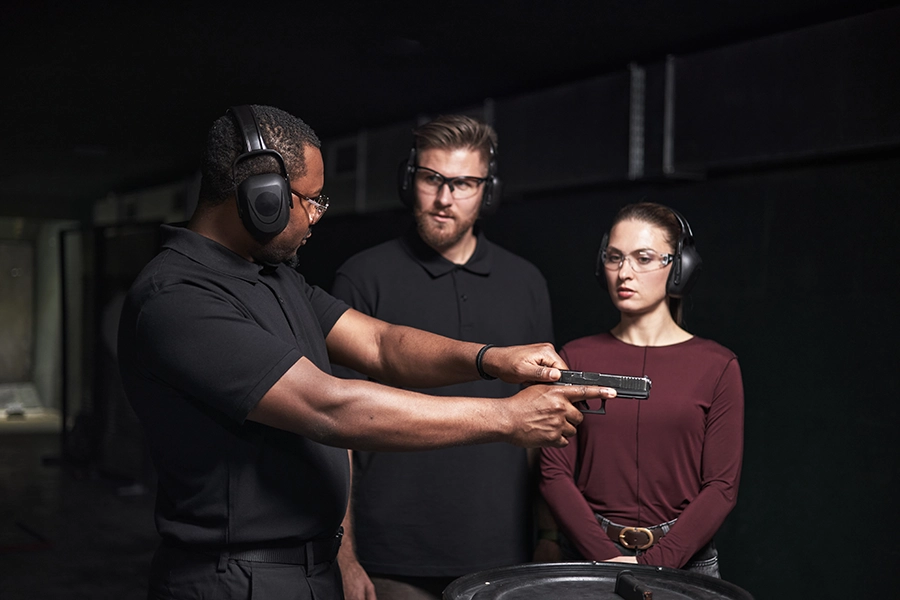 Instructor teaching firearms to students